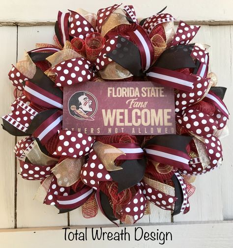 This Florida State University wreath is a must have for “NOLES” fans!!  This wreath is created by using deco mesh and wired ribbon all using FSU colors.  A wooden “Florida State Fans Welcome” sign is located in the center of the wreath to complete the look.    Show your team spirit by displaying this wreath on your front door, office door, or any room in your home all year!  Approximate size is 24” x 6”. College Wreaths For Front Door, Football Team Wreaths, College Wreaths, Wall Wreath Decor, College Crafts, Door Office, Deco Mesh Wreaths Diy, Door Hangings, Football Wreath