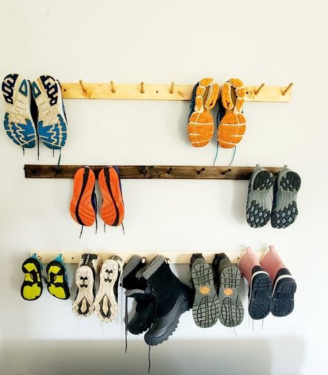 A handmade wooden rack with pegs that are perfect for boot storage, though you can also totally use it for hats, sneakers, and any other accessories you need before you head out the door. Garage Shoe Organization, Mud Room Cubby, Boot Storage Ideas, 1960 Home, Garage Shoe, Garage Shoe Storage, Shoe Rack Wall, Wall Shoe Storage, Cozy Cottage Living Room