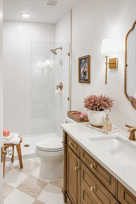 Light and bright guest bathroom with neutral wood tones, creamy whites, and pops of pink! It was important for this space to feel bright and inviting as this space does not have much natural lighting

Spring style, guest bathroom, light and bright, neutral wood tones, creamy whites, pops of pink, gold detail, wall sconce, vanity finds, neutral home, aesthetic finds, gold mirror, Wayfair, Michael’s, found it on Amazon, Target style, bathroom refresh, Small Natural Bathroom Ideas, Mom Bathroom Ideas, Bathroom With White Tile Floor, Bathrooms With Tan Tile, Stand Up Shower Bathroom, Tan Bathroom Ideas Decor, Classic Small Bathroom Ideas, Bathroom Remodel Small Space, Small Transitional Bathroom