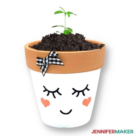 Terra-Cotta pot painted with with a peaceful vinyl face decal and a growing sprout from Dollar Tree Cricut Projects. Dollar Tree Vinyl Projects, Dollar Tree Cricut Projects, Dollar Tree Vinyl, Terra Cotta Pot Projects, Diy Dollar Tree Crafts, Dollar Tree Cricut, Terra Cotta Pots, Clay Pot People, Plant Pot Diy