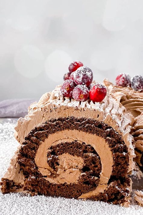 This delicious Homemade Yule Log Cake is made with a rich, chocolate sponge cake and wrapped in a chocolate buttercream frosting. Grab a fork to texture the frosting to look like tree bark and dust it with powdered sugar. It's the perfect cake for the Christmas dessert table and tastes great! Diy Yule Log, Yule Log Decoration, Traditional Yule Log, Cake Recipes Chocolate, Log Cakes, Yule Log Cake Recipe, Classic Holiday Desserts, Yule Log Recipe, Festive Holiday Desserts