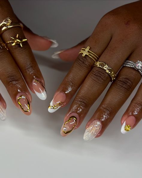 ✨🐚🌞 @shopagaloreco products used: *malt base *ultra white *gold fairy *bling gel *diamond steel top coat use code ‘ALEXIA10’ at checkout 🤎 #nails #nailinspo #nailideas #naildesign #nailartist #whitenails #shellnails #beachnails #cutenails #almondnails #pearlnails #cltnails #cltnailtech #gelx #gelxnails #gelxinspo #gelxnailtech #almondnails Gold And White Nails, Ultra White, Pearl Nails, Beach Nails, Nail Artist, Nail Tech, Almond Nails, White Nails, Top Coat