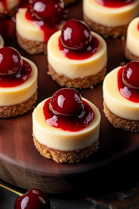 A view of several mini cheesecakes neatly arranged on a wooden platter. Each cheesecake is topped with a cherry and cherry sauce, highlighting the luxurious texture and vibrant color of the desserts. Friendsgiving Desserts, Friendsgiving Dessert, Easy Mini Cheesecakes, Thanksgiving Cheesecake, Potatoes Thanksgiving, Jordan Cake, Mini Cherry Cheesecakes, Mashed Potatoes Thanksgiving, Stuffing Thanksgiving