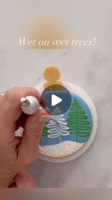 Mary Mansfield on Instagram: "I had the pleasure of creating this ornament cookie design for @annclarkcookiecutters 🌲 It’s another fun wet on wet technique, that’s quite simple to do. Visit the Ann Clark website to see more tutorials on how to decorate this shape in other ways, as well as design inspiration for other ornaments and holiday shapes!🌲❄️🌲  #cookievideo #cookiedecoratingvideo #cookiedecoratingtutorial #cookietutorial #royalicingtransfers #christmascookies #royalicing #ornamentcookies #wetonwetcookies  #royalicingcookies #decoratedcookies #icingcookies #decoratedsugarcookies  #cookiedecorating #cookiesofinstagram" Royal Icing Christmas Cookies, Holiday Cookies Decorated, Wet On Wet Technique, Royal Cookies, Christmas Cutout Cookies, Flooding Cookies, Wreath Cookies, Cutout Cookies, Royal Iced Cookies