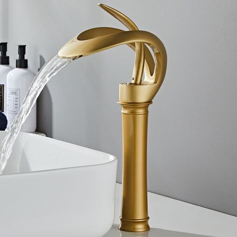 Create a modern class with the gold waterfall bathroom faucet. Its wide spout is complemented by contemporary lever handles, sure to add elegance to any bathroom. Built from lead-free solid brass composition, this faucet is a durable and attractive piece to renew your bathroom with contemporary appeal. Designed with a single handle, it is a breeze to adjust the water flow and temperature precisely.- Constructed from solid brass for durability and reliability.- Finished in high quality, corrosion Black And Brass Bathroom, Bathroom Sink Faucets Waterfall, Black Bathroom Sink, Gold Bad, Brass Bathroom Faucets, Waterfall Bathroom, Bathroom Faucets Waterfall, Vessel Faucets, Vessel Sink Faucet