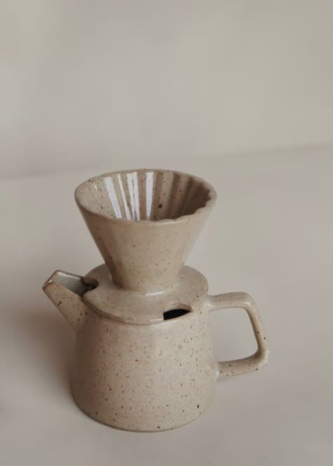 Brighten up your mornings with the Ratih Pour Over. Handmade in smooth ceramic in a V-shaped cone design with ribbed inner design to lengthen the extraction process for a greater brew. Pairs perfectly with Ageng Tea Pot / Speckled Cream. This pour over is part of the Kayu Studio ‘Tanah Liat’ Collection — which directly translates into Clay Collection in Javanese. This handmade collection is made by our skilled partners in Java, Indonesia. Dedicated to ethical practices, this little ceramics stud Ceramic Drip Coffee, Pour Over Ceramic, Pottery Creative Ideas, Ceramic Coffee Pour Over, Ceramic Pour Over, Tea Pot Pottery, Pitcher Design, Tea Pot Ceramic, Pottery Tea Pots