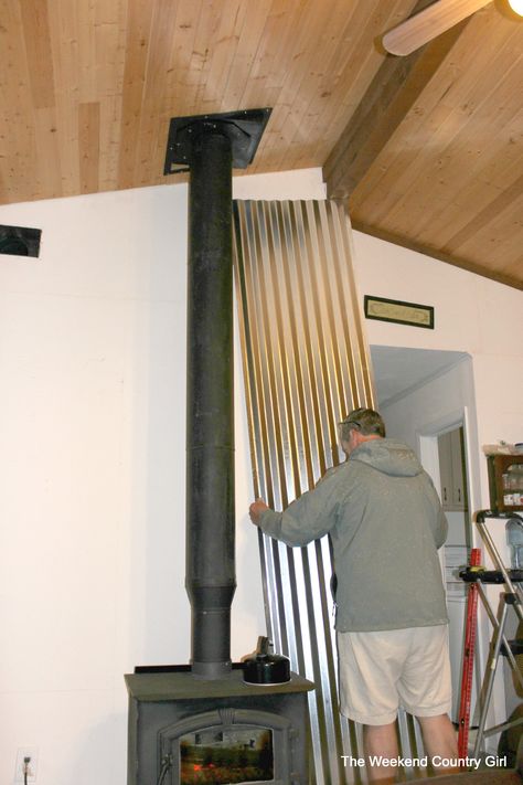 how to install a corrugated tin wall - The Weekend Country Girl featured on @Remodelaholic Wood Stove Heat Shield, Wood Stove Decor, Wood Burning Stove Corner, Corner Wood Stove, Wood Stove Surround, Wood Stove Installation, Wood Stove Chimney, Wood Stove Wall, Stove Decor