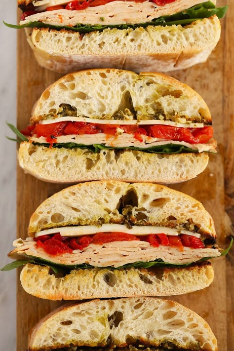 Forget the subway party platter and make this Grilled Roasted Red Pepper, Pesto, & Turkey sandwich! It is perfectly toasted on the grill and a great meal for the family or a larger group at a bbq! Roasted Red Pepper Pesto Chicken Sandwich, Deli Turkey Sandwich, Sandwich With Roasted Red Pepper, Peppered Turkey Sandwich, Roasted Turkey Sandwich, Turkey Roasted Red Pepper Sandwich, Roasted Red Pepper Sandwich, Roasted Red Pepper Wrap, Red Pepper Sandwich