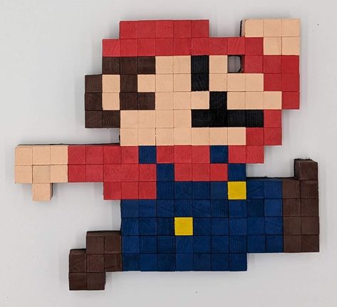 "Check out this awesome 8-bit Retro Jumping Mario from Super Mario Bros, crafted with care from solid hardwood. It's a nostalgic pixel art masterpiece, meticulously assembled from individually cut wooden pieces that were painted and placed on a 1/4\" board to create this cool gaming decor item. Whether you want to spruce up your game room, add some flair to your workspace, liven up a kid's room, or just enhance your home's vibe, this piece is a fantastic choice. You can hang it on the wall using the included sawtooth hanger, or let it stand alone as a striking figure. The pixels here aren't just flat; they've got varying grain and colors to capture the character's iconic look. It's the perfect blend of nostalgia and craftsmanship, and it's ready to be a standout feature in your space. ⚠️ T Pixel Art Wall, 8 Bit Pixel Art, Pokemon Room, Geeky Craft, 8 Bit Art, Pixel Characters, Gaming Tattoo, Pixel Art Games, Gaming Decor