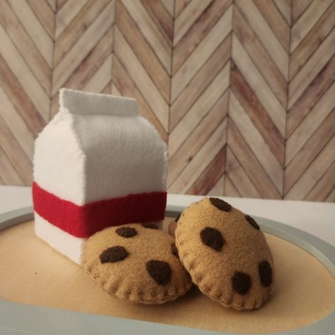 Felt milk carton in white with a red stripe accompanied with 3 tan cookies with chocolate chips on a tray with wooden background. Felt Milk Carton, Felt Food Diy, Felt Play Food, Milk Carton, Milk N Cookies, Bestie Gifts, Felt Food, Play Food, Felt Ornaments