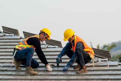 Worker with hooks for safety harness | Premium Photo Flat Roof Repair, Roof Work, Concrete Roof Tiles, Roof Inspection, Roof Maintenance, Commercial Roofing, Roofing Companies, Concrete Roof, Cool Roof