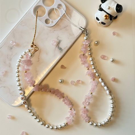 Length: around 17 CM Elevate your phone's style with this personalised phone charm, featuring natural rose quartz crystals and crystal glass pearls. Handmade with love, each charm is unique and customisable with your choice of initials or name. The soothing rose quartz and elegant pearls make it both beautiful and meaningful. It's perfect for adding a personal touch and keeping your phone secure. This charm also makes a thoughtful and personalised gift for loved ones. Customize your phone charm today and carry a piece of personalised elegance with you! Pearl Phone Charm, Beaded Designs, Red Quartz, Mask Chain, Phone Charms, Boho Chic Jewelry, Eye Glass, Phone Strap, Crystal Rose