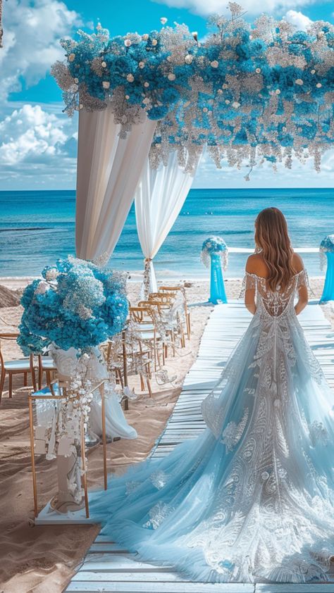 A bride stands at a beautifully decorated beach wedding entrance, surrounded by stunning seaside decor, ready for her special day. Beach Venues For Weddings, Blue Beach Wedding Decorations, Wedding Venues By The Sea, Wedding Arches Beach, Beach Color Wedding, Sunflower Beach Wedding Ideas, Wedding In Water, Beach Villa Wedding, Disney Beach Wedding