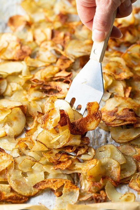 Crispy Roasted Potatoes Recipe - Tender and crunchy potato ribbons are a fun, healthier side dish that go well with nearly any main. You'll love this easy twist for updating those classic meat and potatoes meals! #roastedpotatoes #crispypotatoes #potatoribbons #crispyroastedpotatoes #aspicyperspective Potatoes Meals, Ribbon Fries, Crispy Potatoes In Oven, Roasted Side Dishes, Roasted Olives, Crispy Baked Potatoes, Baked Potato Chips, Crunchy Potatoes, Potatoes In Oven