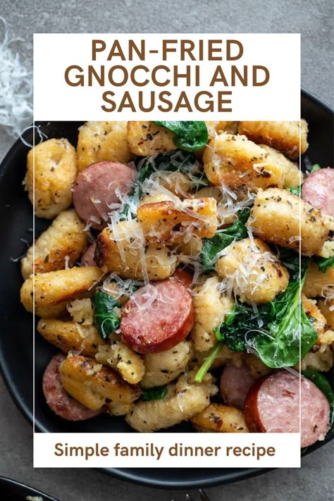 Pan-fried gnocchi with sausage and spinach on a black plate. Italian Sausage And Gnocchi Recipes, Kielbasa Gnocchi, Gnocchi And Chicken Sausage, Gnocchi With Sausage, Gnocchi With Spinach, Fried Gnocchi, Pan Fried Gnocchi, Andouille Sausage Recipes, Gnocchi Recipes Easy