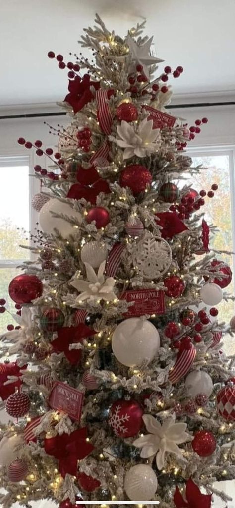 Santa Clause Themed Tree, Red Glam Christmas Tree, Flocked Christmas Tree Red Ornaments, Christmas Tree Ideas Flowers, Red Decor Christmas Tree, Snowflake Christmas Tree Theme, Christmas Tree With Poinsettia Flowers, Cardinal Christmas Tree Ideas, Red And Champagne Christmas Tree