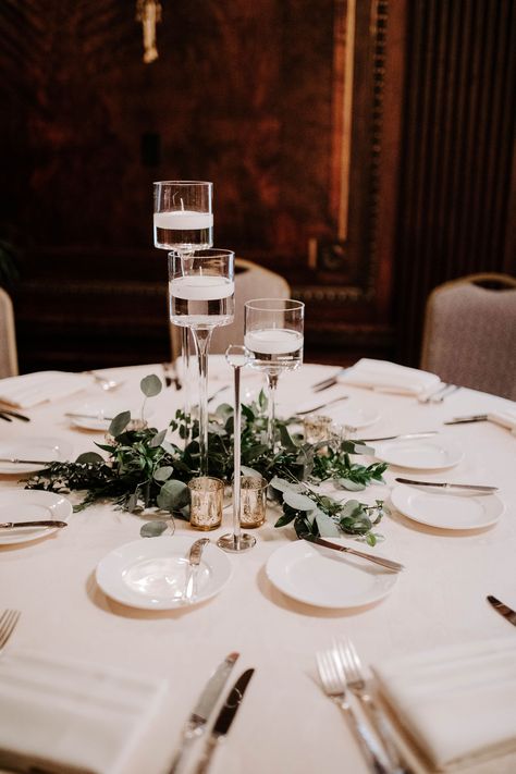 Mixed greenery and eucalyptus with stemmed floating candle vases by Creations By Debbie in Nashville, TN.  #NashvilleWeddings #UnionStationNashville #WeddingCenterpieces Circle Table Centerpiece Wedding, Circle Table Wedding Decor, Floating Candle Vase, Wedding Decor Rentals, Eucalyptus Centerpiece, Stemmed Candle Holders, Floating Candles Wedding, Glass Vases Centerpieces, Arte Aesthetic