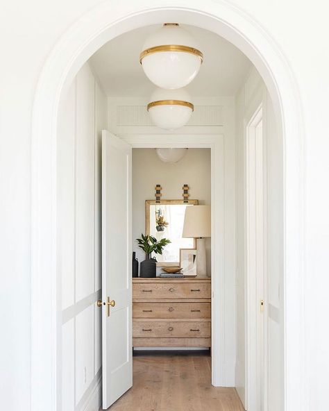 Studio McGee. Hallway globe ceiling pendant lights, white paint, tall ceilings, round arch interior. The Mcgee Home, Interior Door Hardware, Mcgee Home, Vintage Console Table, The Shade Store, Bedroom Photos, Studio Mcgee, Trending Decor, Light Fixture