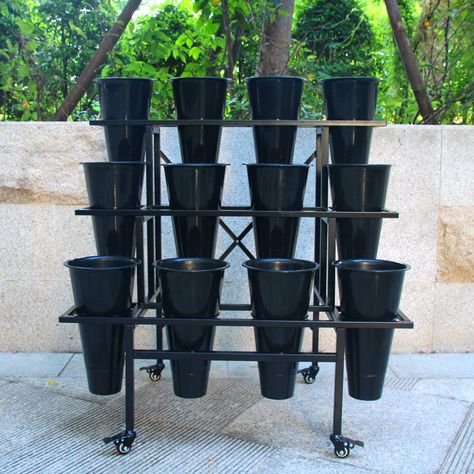 PRICES MAY VARY. 3 Tier Sturdy metal frame: Heavy Duty Construction. 35.43 x 22.44 x 34.65 inches 12 Pcs Plastic Buckets. Each conic vase Dia. 8" Tall 14". Powder coated steel frame:Rustproof and weather resistant. Easy Assembly: Components and instructions are included for quick installation. Swivel casters rotate 360 degrees.This flower display stand moves very easily, 4pcs casters with brakes. The wheels rolls smoothly and does not mar the wood floors. Zhongma Moving Plant Stand with Wheels H Flower Display Stand, Moving Plants, Plant Stand With Wheels, Corner Plant, Tall Plant Stands, Garden Shelves, Garden Cart, Metal Plant Stand, Wood Plant Stand