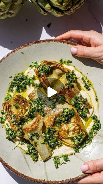 Maddie & Jules on Instagram: "Artichoke hearts on a bed of whipped ricotta topped with herb gremolata are our favorite way to enjoy artichokes.   For full artichoke recipe link in bio or visit https://kitchen-by-the-sea.com/artichoke-hearts-with-herb-gremolata/  Ingredients Artichokes 3 artichokes 1 tablespoon peppercorn 1 tablespoon salt 1 lemon cut in half 2 tablespoon olive oil for frying Gremolata: ½ cup extra virgin olive oil 3 tablespoon finely chopped chives 3 tablespoon finely chopped parsley ½ bunch of mint finely chopped (~3 tablespoons) 1 stem of green garlic or 1 medium clove of garlic finely minced 1 tablespoon lemon juice Zest of 1 lemon Salt and pepper to taste Whipped ricotta: 6 oz ricotta Zest of 1 lemon 1 tablespoon olive oil ¼ teaspoon salt more to taste ¼ teaspoon peppe Artichoke Recipe, Ooey Gooey Bars, Whipped Ricotta, Gooey Bars, Green Garlic, Artichoke Recipes, Lemon Salt, Ooey Gooey, Artichoke Hearts