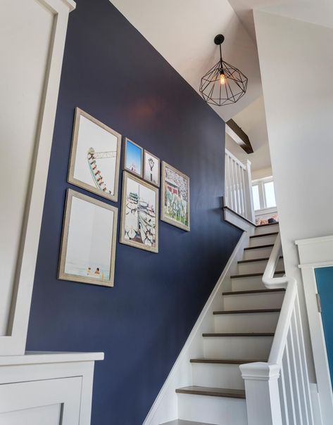 This old classic shingle-style home – staircase Navy Staircase Wall, Blue Staircase, Caged Chandelier, Blue Hallway, Open Trap, Hallway Colours, Blue Accent Walls, Stair Wall, Staircase Wall