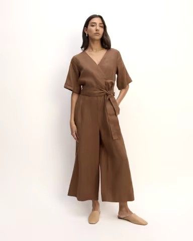 Embrace effortless elegance with The Wrap Jumpsuit in Linen in Brown. This stylish jumpsuit features a flattering wrap design and breathable linen fabric, perfect for both casual and dressy occasions. The rich brown hue adds a touch of sophistication, while the versatile silhouette ensures comfort and chic style. Shop now to elevate your wardrobe with this must-have, modern jumpsuit! Brown jumpsuit. Culotte Style, Olive Green Jumpsuit, Flowy Jumpsuit, Brown Jumpsuits, Vintage Suede Jacket, Wrap Jumpsuit, Guest Attire, Wedding Attire Guest, Linen Jumpsuit