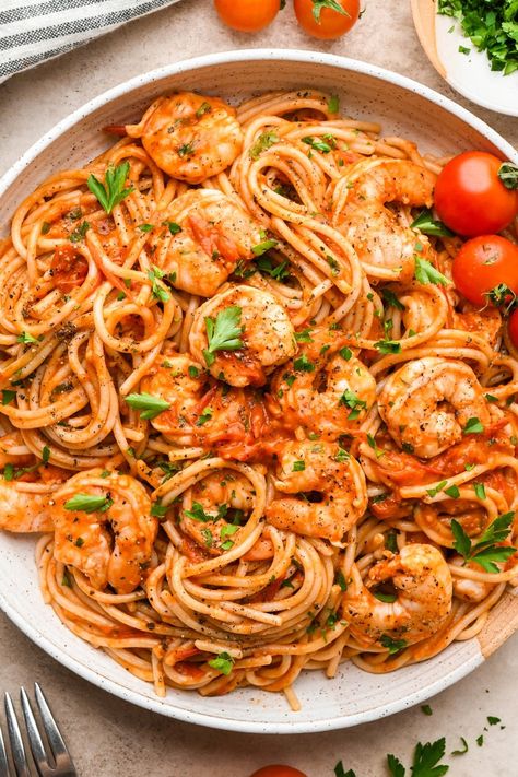 This simple burst cherry tomato and shrimp pasta is so simple but so incredibly flavorful! Made with fresh cherry tomatoes, lots of garlic, and a little bit of tomato paste to bolster the tomato flavor, it is made without cream and dairy free. We opt for GF pasta to keep the recipe gluten free, but any pasta you like will work! It is all cooked in one skillet and ready in just 30 minutes. Adding chopped parsley brings some color and elegance to the dish, making it just as perfect for serving guests as it is for a quick weeknight dinner. Tomatoe Shrimp Pasta Recipes, Shrimp Cherry Tomato Pasta, Pasta Sauce With Cherry Tomatoes, Shrimp Tomatoes Pasta, Blistered Cherry Tomatoes Pasta, Shrimp Sun Dried Tomato Pasta, Shrimp And Tomato Pasta, Pasta Recipes With Cherry Tomatoes, Shrimp Spaghetti Recipes