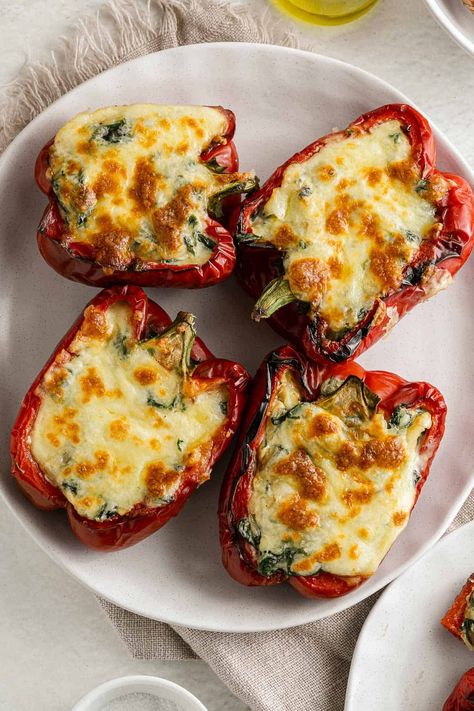 These Cheesy Spinach Stuffed Peppers are the perfect easy weeknight meal. Tender, roasted peppers, stuffed with a rich, creamy spinach filling, and topped with melty cheese. They are low carb, gluten free, and vegetarian. Spinach Stuffed Peppers, Mushroom Stuffed Peppers, Spinach Filling, Peace Love And Low Carb, Dinner Recipe Ideas, Low Carb Sandwiches, Mushroom Stuffed, Spinach And Mushroom, Cheesy Spinach