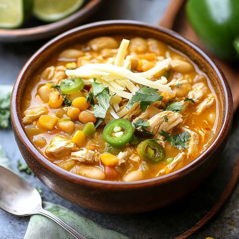 A hearty and flavorful Spicy White Chicken Chili with tender chicken, beans, and a spicy kick. Perfect for a cozy dinner. Ready in under an hour! Spicy White Chicken Chili, Creamy White Beans, Spicy Chicken Soup, Chicken Beans, White Chicken Chili Recipe, White Bean Chili, White Chili Chicken Recipe, Traditional Chili, Cozy Dinner