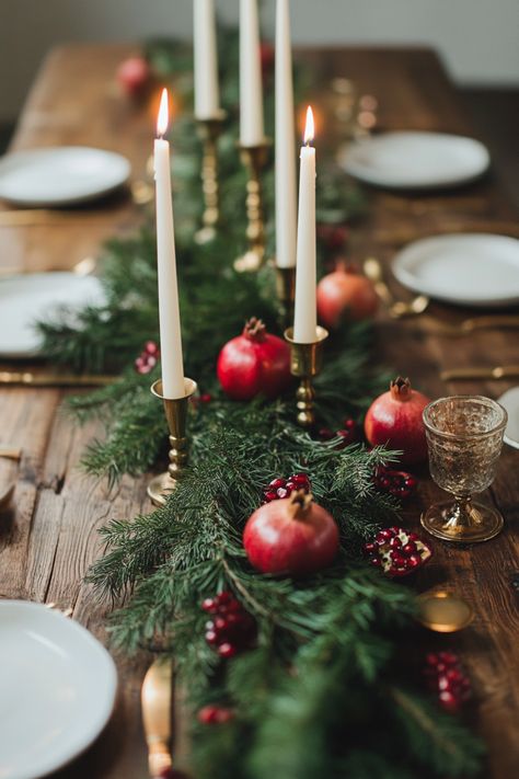 Looking for an easy and budget-friendly way to make your holiday table festive? This DIY elegant Christmas centerpiece features natural elements like fresh pomegranates and lush evergreen branches. It's a cheap yet stunning way to bring a touch of elegance to your Christmas décor Fresh Christmas Table Centerpieces, Christmas Pomegranate Decoration, Christmas Dinner Party Table Decor Diy, Pomegranate Decoration Table Settings, Table Scapes Christmas Holiday, Pomegranate Christmas Decor, Budget Christmas Table Decor, Pomegranate Table Decor, Christmas Table Flowers