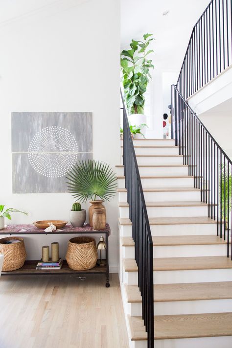 Traditional Home Bohemian Remodel Inspiration | Apartment Therapy 1980s Home Remodel, Wood Shingle Siding, Wrought Iron Banister, Banister Remodel, 1980s Home, Exposed Rafters, Remodel Inspiration, Entrance Foyer, Home Remodel