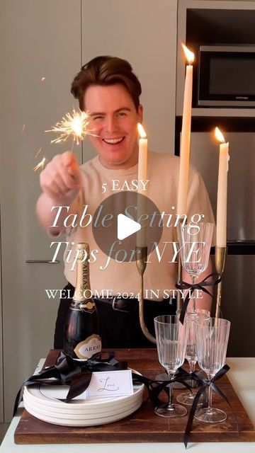 Loui Burke on Instagram: "New Year’s Eve table setting tips. 
When I think new year’s, I think fancy. And when I think fancy, I think French. And nothing quite says French and fancy like a black and white theme. 

My tips; 

🥂Add in a touch of beige to soften the look and take it to a new level. 

🥂 You can add an elegant and playfulness effect to your tablescape using ribbon and bows. And despite what people on here will say about bows and ribbons, you can’t say they’re not chic and classic. 

🥂 Also a menu and coaster are extra little personalised details you can add to make a minimalist table feel fuller without taking away its simplicity. 

🥂 Don’t forget a place card. There’s not one person who doesn’t love a welcome note/ their name on a table. 

Happy New Year! 🥂✨" Round Table Set Up, Black And Silver Round Table Setting, Minimalist New Year Table Set Up, New Year’s Eve Table Setting, New Year Table Setting Ideas, Black And Silver Table Setting, Noon Years Eve Birthday Party, New Years Party Favor Table, New Year’s Eve Napkin Fold