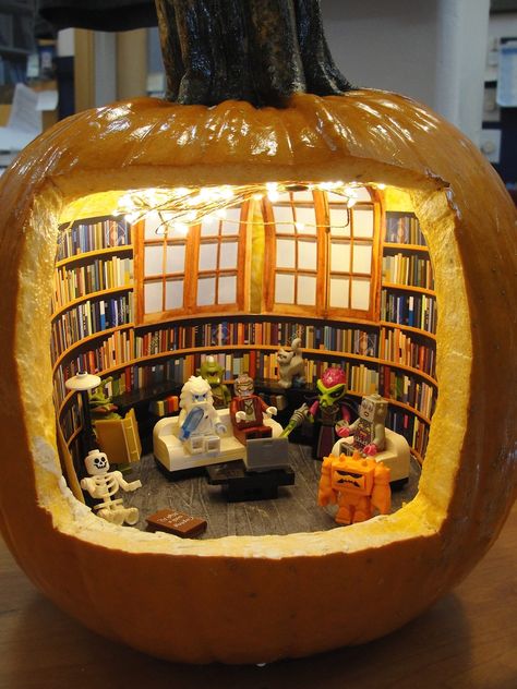 photo of a pumpkin with a large opening carved in the front to reveal a tiny library with shelves of books a large window in the back and Lego characters enjoying the space Truro Massachusetts, Pumpkin Diorama, Pumpkin Contest, Pumpkin Carving Designs, Halloween Pumpkins Carvings, Library Displays, Truro, Carving Designs, Pumpkin Decorating