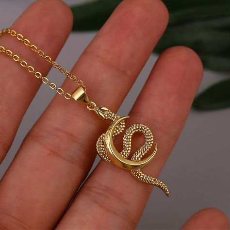 This snake jewelry piece showcases a delicate and dainty design. The snake symbolizes transformation, rebirth, and wisdom, while the moon represents feminine energy, intuition, and cycles of life! Our necklace serves as a unique expression of style and personality. It's an exquisite piece that effortlessly complements any outfit, adding a touch of mythological allure to your look. It also makes a thoughtful gift for that special someone in your life. ✨ ✦ NECKLACE DETAILS: * Pendant Size: 3.7 Centimeters // 1.5 Inches * Chain Length: Adjustable 45-50 Centimeters // 17-19 Inches * All our work is custom-made by hand with love 💖 ✦ FREE SHIPPING + 15% OFF (4-9 Days) --- Do you love this item and want to buy it later? Just click on the heart-shaped icon to your right to add it to your favorite Cheap Snake Chain Necklace For Women As A Gift, Luxury Goddess Style Necklace For Gift, Cheap Snake Chain Necklace As A Gift, Luxury Mystical Necklace For Gift, Luxury Symbolic Necklaces For Women, Luxury Mythological Pendant Necklaces, Luxury Symbolic Snake-shaped Jewelry, Luxury Elegant Snake Necklace, Luxury Adjustable Snake-shaped Jewelry