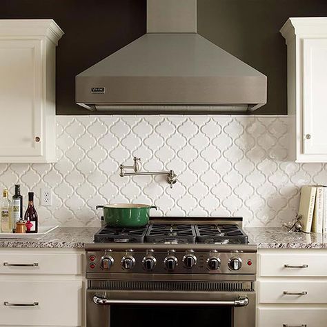 Quatrefoil-pattern tiles add subtle dimension and texture to this pretty kitchen: http://www.bhg.com/kitchen/backsplash/behind-the-range-tile-backsplash/?socsrc=bhgpin040714patternedtilebacksplash&page=4 Dr Kitchen, Backsplash Arabesque, Pot Fillers, Range Tile, Trendy Kitchen Tile, Trendy Kitchen Backsplash, Patterned Tile Backsplash, Moroccan Lantern, White Tile Backsplash