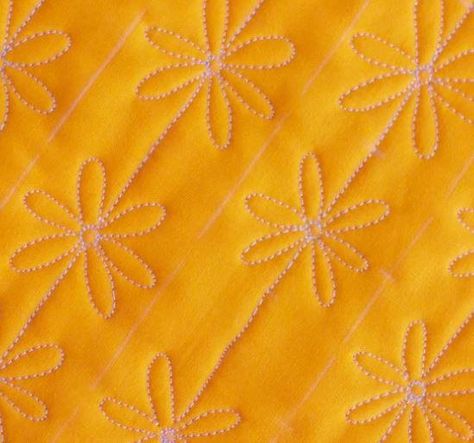 Add a little sunshine to your next quilt project with this simple free motion tutorial that's great for machine quilters. This Daisy Chain Free Motion Tutorial is a simple way to add some beautiful summery details to your next quilt, and comes with step-by-step images for creating your chain of daisies. This &lt;a href=&quot;https://www.favequilts.com/tag/Free-Motion-Quilts&quot; target=&quot;_blank&quot; title=&quot;Free Motion T... Feather Wreaths, Free Motion Quilt Tutorial, Machine Quilting Tutorial, Quilting Stitch Patterns, Flower Quilt Patterns, Quilting Tutorial, Free Motion Pattern, Free Motion Designs, Free Motion Quilting Patterns