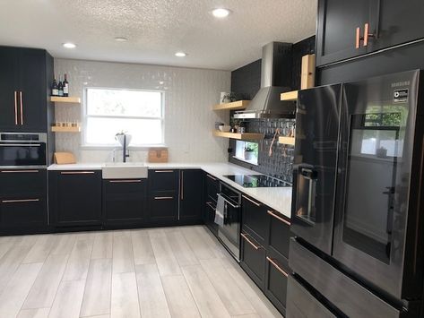 Specifically, this IKEA kitchen features IKEA’s SEKTION cabinetry framework with IKEA LERHYTTAN upper and base cabinetry with black stain. The look is complemented by Bedrosian’s white quartz countertops, called Bright Paradise, which are featured in an L-shaped design around the perimeter, and light wood flooring. Ikea Black And White Kitchen, Black Ikea Kitchen Cabinets, Ikea Black Cabinets, Ikea Black Kitchen, Black Ikea Kitchen, Kitchen Soffit, Black Appliances Kitchen, Ikea Kitchen Remodel, Kitchen Ikea