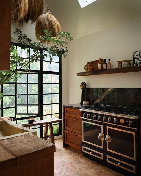 The kitchen in @aurorajames's Laurel Canyon home features some treasured finds, including a 1,000-pound stone sink. (“Getting that in was a whole thing,” she admits.) There are also the Congolese grass pendants that she picked up from a street vendor in Greece. (“They make the kitchen feel so much more textural and cultural to me,” she says.) Take a tour of the vibrant retreat in our September cover story at the link in our bio. Photo by @frankfrancesstudio; styling by @amykchin; design by @... Architectural Digest Kitchen, Laurel Canyon Home, Stone Kitchen Sink, House Cozy, Mediterranean Interior Design, Mediterranean Interior, Earthy Home, Eclectic Interior Design, Street Vendor