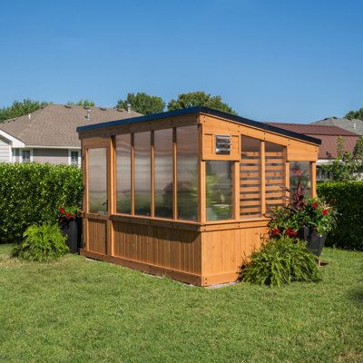 Elevate your gardening with a modern greenhouse masterpiece. Step inside and you'll discover a spacious interior that invites you to dig into your passion for gardening like never before. Combining forced and passive ventilation, you can nurture plants year-round. And features like foldable shelves, a hose hook-up, and PowerPort™ make it complete so you can unleash your green thumb in style. | Backyard Discovery 12 x 7 Zalie Modern Greenhouse 94.1 H x 86.22 W x 137.8 D in brownWood / Polycarbona Foldable Shelves, Passive Ventilation, Modern Greenhouse, Cedar Greenhouse, Modern Greenhouses, Polycarbonate Greenhouse, Polycarbonate Panels, Wooden Greenhouses, Backyard Greenhouse