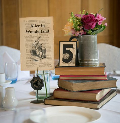 Vintage table decor ideas | Alice in wonderland page extract with vintage books table decor |  Vintage ideas | Lizzie and Greg’s Real Wedding | Confetti.co.uk Books Table Decor, 21st Birthday Parties, Wedding Tablescapes Round, Book Lovers Wedding, Books Table, Mom Decor, Vintage Table Decor, Table Decor Vintage, Book Centerpieces