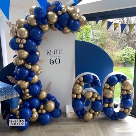 Inspo for Mens’s Birthday Decor. Celebrating 60 in Style with this Backdrop and Balloon Display in Royal/Navy Blue and Gold. With 3 x Sailboard Backdrops, Vinyl Personalisation, Balloon Garland and Balloon Mosaic ‘60’. #mensbirthday #birthdaydecorationsfordad #birthdaydecoration #balloongarland #balloonmosaic #60thbirthday Men 60th Birthday Ideas Themed Parties, Men 60th Birthday Party Ideas Decoration, Balloon Garland For Men, Royal Blue Balloon Garland, Birthday Backdrop For Men, 60th Birthday Party Themes, Blue And Gold Birthday, 60th Birthday Ideas For Mom, Navy Blue Backdrop