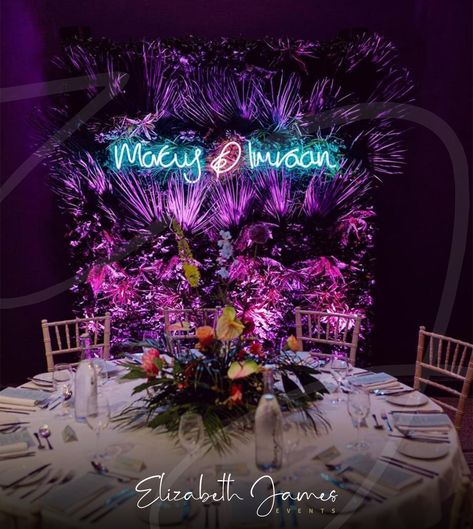 Incredible Wedding Backdrop for Marcus & Imraan ⚡️🌿💖 Working with the wonderful @lndevents, we created a Custom Neon Sign (in the couple's very own handwriting), hung it from our Extra Tropical Foliage Wall and added our Pink Uplighters for this epic Miami-Vice inspired full backdrop ⚡️🌿💖 Epic floral table centrepieces by @hydeparkflowerclub.by.dotties 🌺 Photos with thanks to @leahweddings 📷 Miami Vice Wedding, Tropical Backdrop, Luxury Event Decor, Foliage Wall, Balloon Installation, Elizabeth James, Light Up Letters, Wedding Event Decor, Floral Table