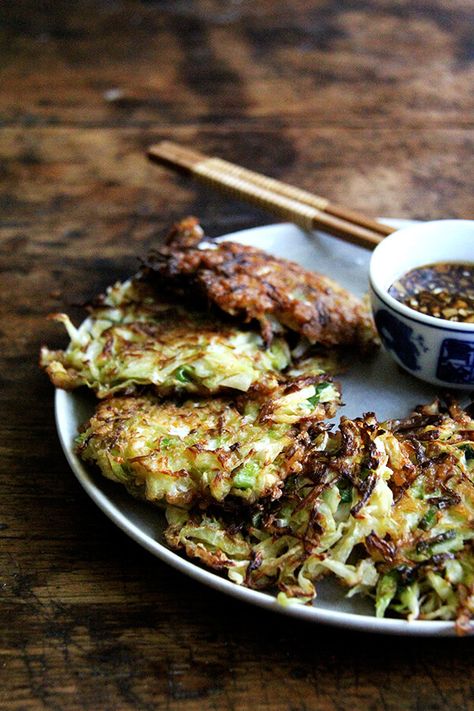 Okonomiyaki — Japanese Cabbage Pancakes — are a winter favorite! Okonomiyaki essentially means "prepared as you like" so know that you can adapt this recipe as you like with shrimp or chicken, sesame seeds or bonito flakes, other vegetables, etc. I love serving them with a soy-based dipping sauce. #okonomiyaki #cabbage #pancakes #newyearseve #appetizers Japanese Cabbage, Cabbage Pancakes, Soy Dipping Sauce, Okonomiyaki Recipe, Vegetarian Cabbage, Cabbage Recipes, Healthy Appetizers, Asian Cooking, Rice Recipe