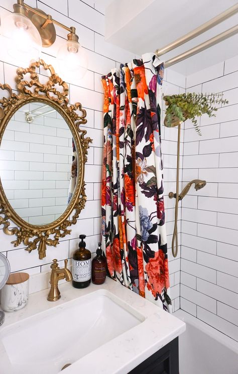 Eclectic Boho Colorful Small Bathroom | Gold Antique Mirror and Fixtures | Bold Floral Shower Curtain | Floor to Ceiling White Subway Tile | Eucalyptus Shower Head