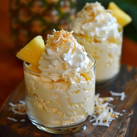 🍍 Dive into our Tropical Pina Colada Cheesecake Mousse! 🍹✨ #PinaColadaMousse #TropicalTreat Tropical Pina Colada Cheesecake Mousse Ingredients: Cream cheese, softened (8 oz) Coconut milk (1 cup) Pineapple juice (1/2 cup) Powdered sugar (1/2 cup) Gelatin (1 tbsp) Heavy cream, whipped (1 cup) Shredded coconut (1/4 cup) Pineapple chunks (for garnish) Instructions: In a bowl, beat cream cheese until smooth. In a small bowl, dissolve gelatin in pineapple juice. Let sit for 5 minutes. Heat coco... Pina Colada Cheesecake, Tropical Desserts, Serving Glasses, Cake Pop Decorating, Pineapple Chunks, Instagram Recipes, Cheesecake Mousse, Twisted Recipes, Trending Recipes