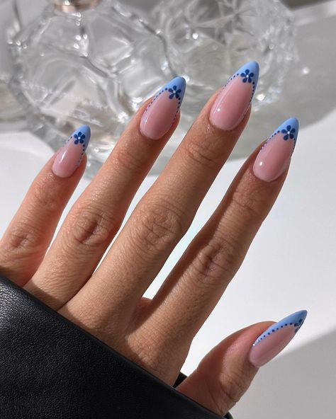 pearlie pressed | blue flower french tips 💙☁️ - what do you think? using @beetlesgelpolish “floral rhapsody” collection - these gels are available through… | Instagram Blue Nail Flower Designs, Light Blue Acrylic Nail Designs, Blue French Tip With Flowers, Cute Blue Acrylic Nail Ideas, Nude Nails With Blue Design, Cool French Tips, Blue Nails Flower, Flower French Nails, Blue French Tip Nails Almond