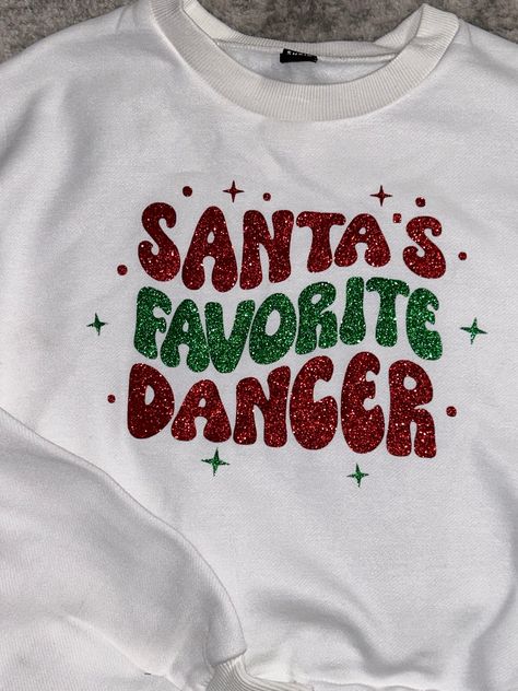 Santa's Favorite Dancer- Dance Christmas Crop Sweatshirt - Dance Team Christmas Sweatshirt- Dancer Christmas This white sweatshirt is made with ALL the bling, show them who is Santa's Favorite. This style is slightly cropped. I also have this available in crop tees, full length sweatshirts, and regular length tees. This also comes in a dance style. Child through adult sizing. This style is polyester. Check out all my holiday items and you can even add plaid shorts to compete the look here: https Christmas Dance Shirts, Christmas Outfits For School, Dancer Style Outfits, Cute Dance Outfits, Christmas Shirt Outfit, Outfit Ideas Shirt, Christmas Sweatshirt Ideas, Christmas Eve Outfit, Dance Christmas