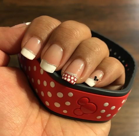 Disney ready, magic band and nails are Minnie inspired. Easy with nail dotting tool. Used white nail polish for the magic band and nail tips. Used red nail polish for nail tips on rings fingers, and used silver striping for accent on nails. Have a steady hand otherwise ask a friend, in this case my daughter helped me! Disney Nails Red Black White, Disney Nails Red, Black Disney Nails, Nails For Disney, Universal Nails, Disney Nail Ideas, Cute Nails Ideas, Mouse Nails, Nail Dotting Tool