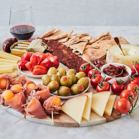 We’re taking a trip to Spain with this DIY tapas-inspired board. A cheese and charcuterie platter that takes snacking to the next level, incorporating some of the best of Spanish and Portuguese flavor onto one party-ready spread. We’ve chosen three incredible cheeses, from approachable Manchego to bold Amanteigado Grande, and paired them with classic chorizo and jamon, as well as sardines. Plus, a selection of sweet, salty, and delectable sides like stuffed peppers and olives, chutney, and ... Manchego Cheese Board, Portuguese Charcuterie Board, Diy Tapas, Tapas Board, Cheeseboard Recipe, Spain Tapas, Tapas Party, Trip To Spain, Party Hosting