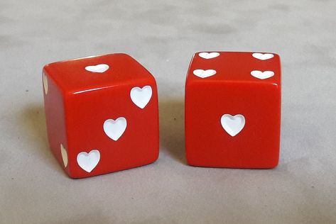 "SHOPPERS A digital proof of your dice will be emailed (through ETSY) for approval within a day of ordering.   PLEASE check your emails and respond ASAP. Dice Size: 25mm (1\") Opaque Red Dice, Square Corner Colors: Opaque Red Pip (spots) Color: White Hearts  Engraving of Text: Around the 1-spot.  Engraving Font: Bebas Neue Regular, 10pt Text Color: White Character Limit: There is a limit of 12 characters (including spaces) for the top and 12 characters for the bottom text. The text will be capit Dice With Hearts, Heart Dice, Dice Design, Dice Tattoo, White Character, Red Dice, Bebas Neue, Wood Burn Designs, Tattoo Flash Sheet